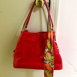 Red coach handbag with matching accent scarf